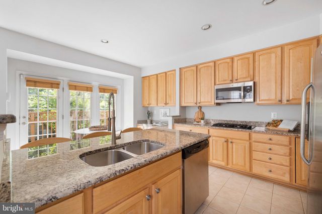 a view of a hallway with wooden floor and windows