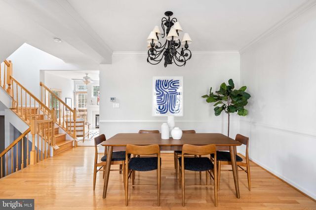 a view of a dining room with furniture wooden floor and a chandelier