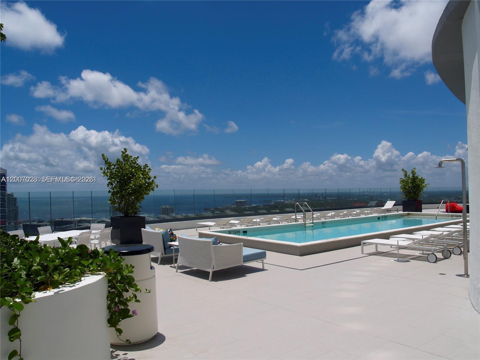 55 Southwest 9th Street, Unit 2502 Miami, FL 33130 - Photo 12 of 27 a view of a swimming pool with a yard