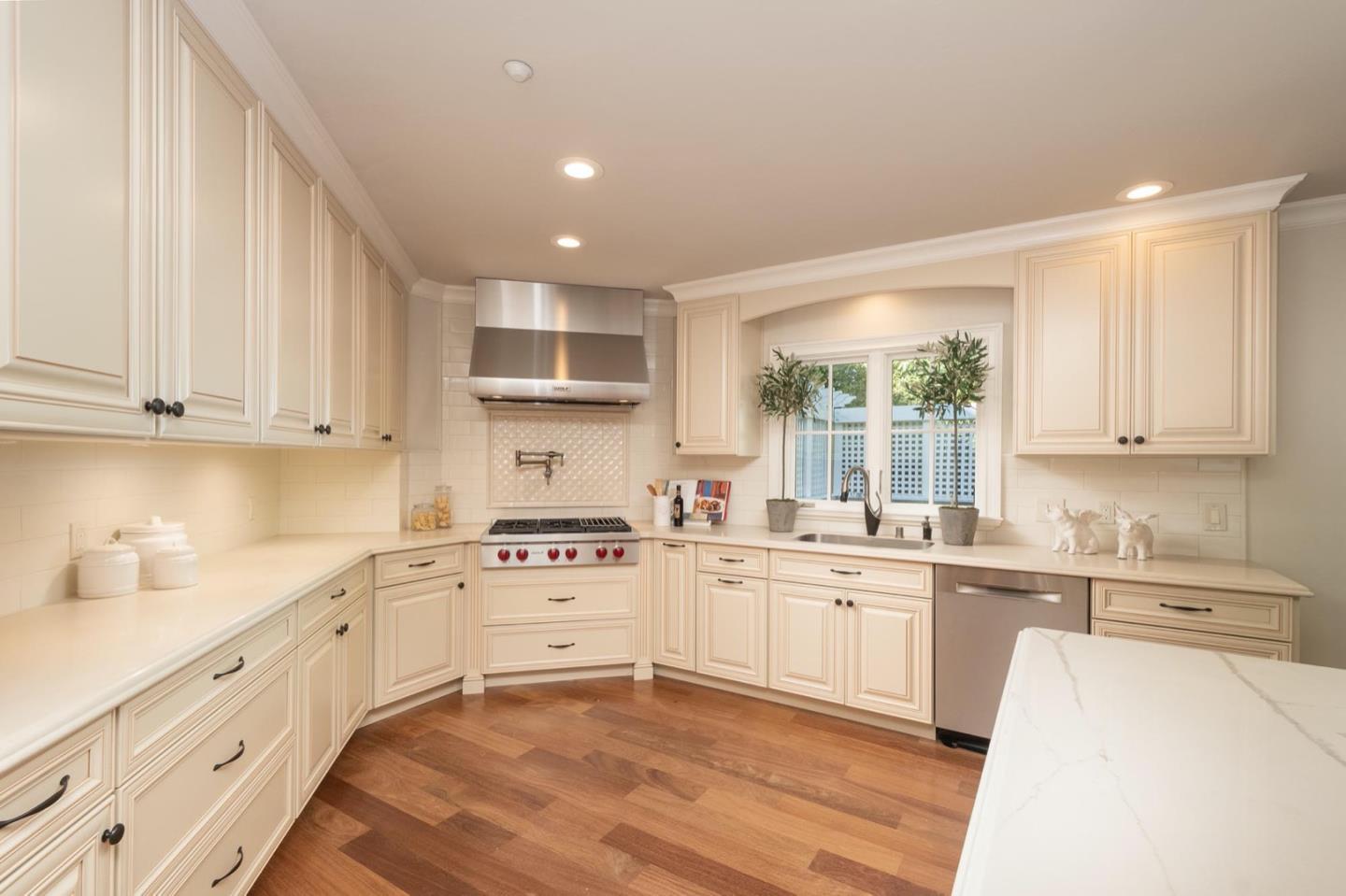 521 Roehampton Road Hillsborough, CA 94010 - Photo 19 of 51 a kitchen with stainless steel appliances granite countertop a sink and cabinets