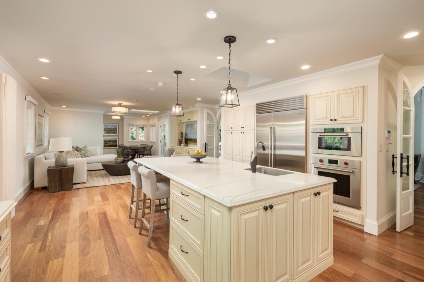 521 Roehampton Road Hillsborough, CA 94010 - Photo 20 of 51 a large kitchen with a large counter top a sink stainless steel appliances and cabinets