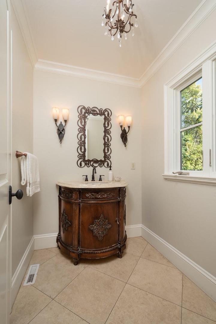 521 Roehampton Road Hillsborough, CA 94010 - Photo 23 of 51 a room with a mirror and a table