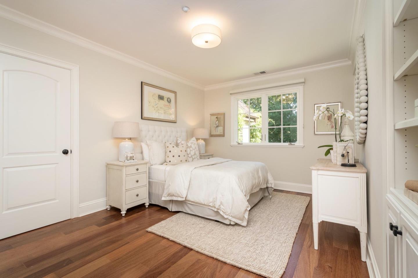 521 Roehampton Road Hillsborough, CA 94010 - Photo 24 of 51 a spacious bedroom with a bed and a table