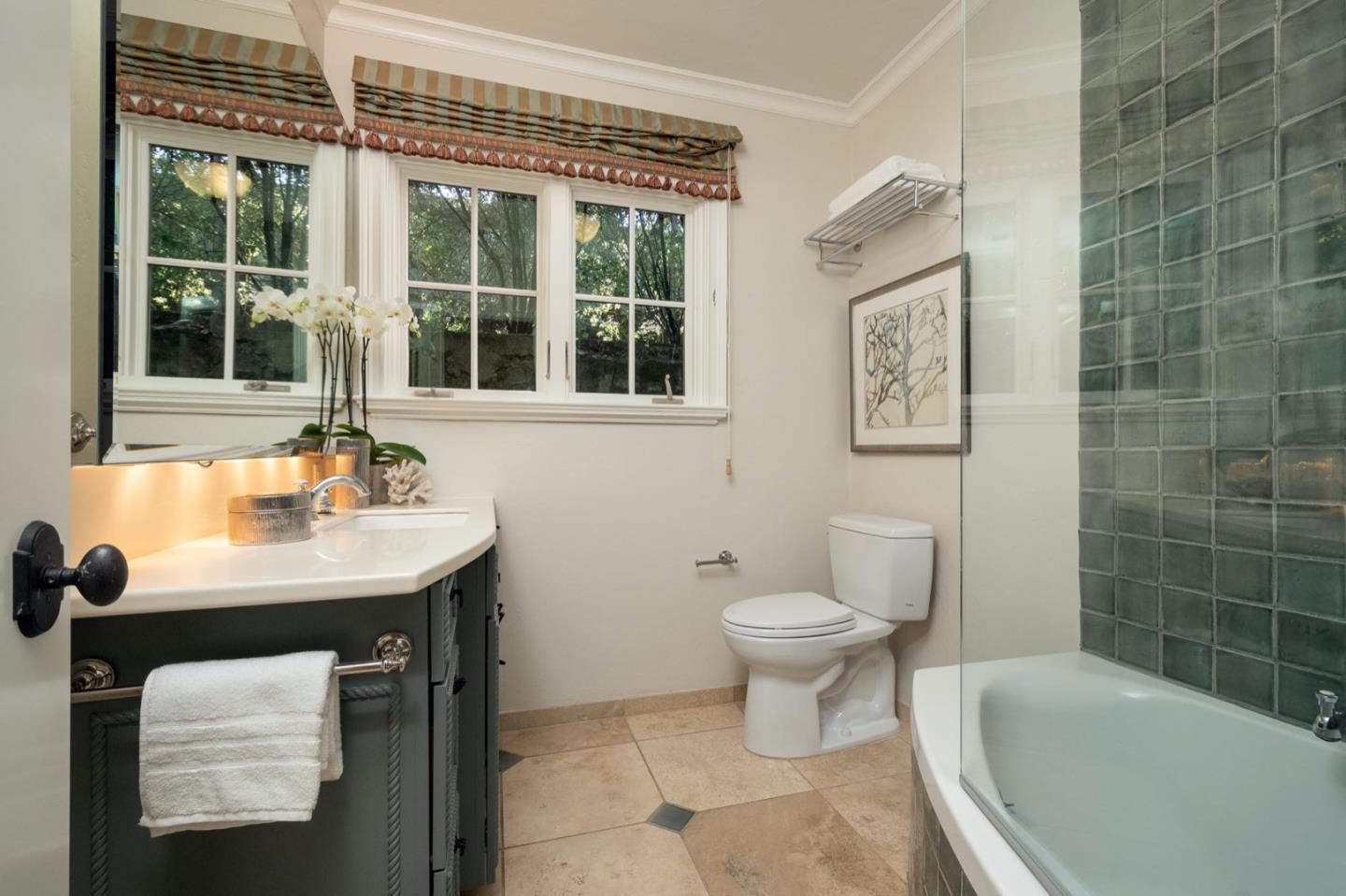 521 Roehampton Road Hillsborough, CA 94010 - Photo 29 of 51 a bathroom with a sink toilet a mirror and tub