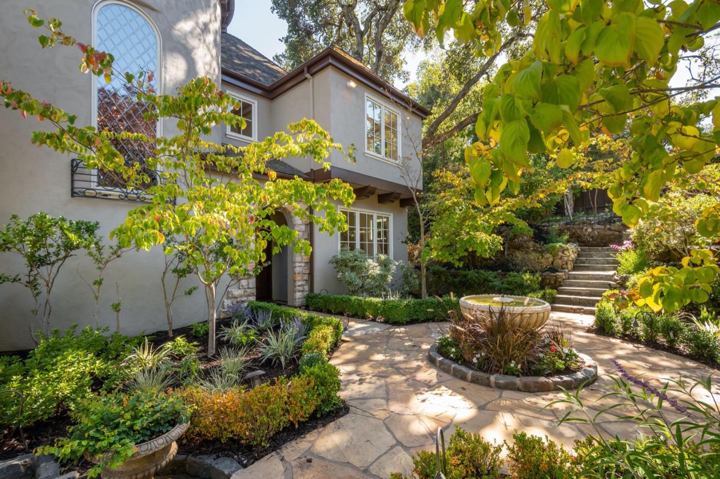 521 Roehampton Road Hillsborough, CA 94010 - Photo 3 of 51 a view of a house with brick walls and flower plants