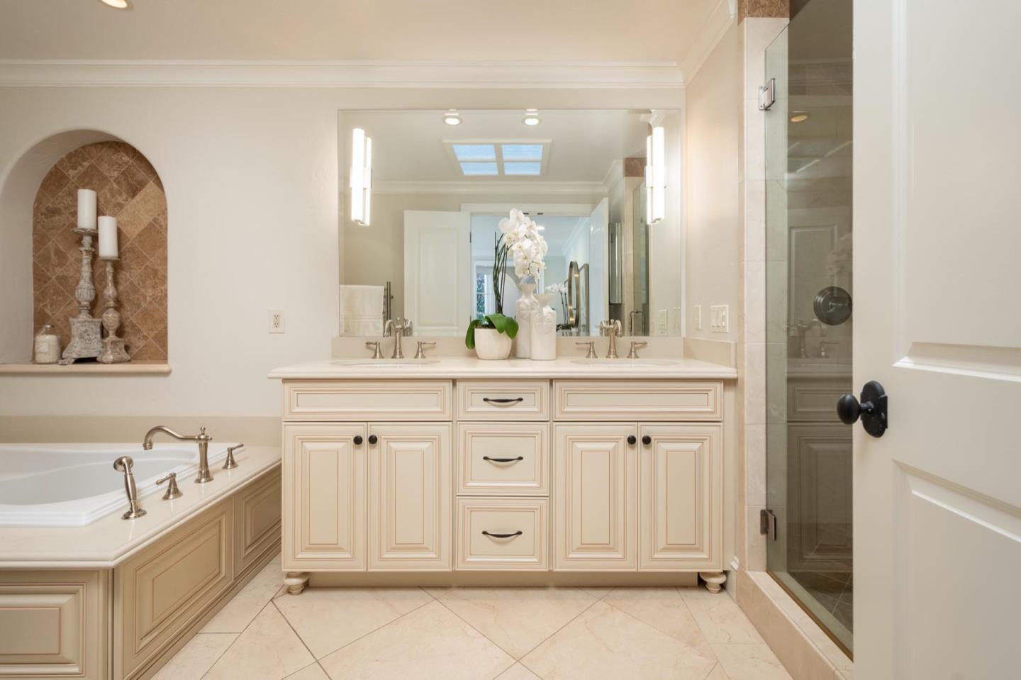 521 Roehampton Road Hillsborough, CA 94010 - Photo 34 of 51 a spacious en suite bathroom with a granite countertop sink and a mirror