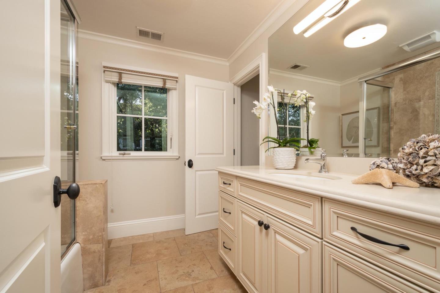 521 Roehampton Road Hillsborough, CA 94010 - Photo 38 of 51 a spacious bathroom with a granite countertop sink a mirror and a shower