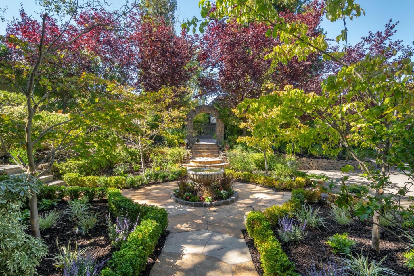 521 Roehampton Road Hillsborough, CA 94010 - Photo 4 of 51 a front view of a house with a yard