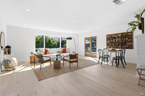 a view of a house with yard and sitting area