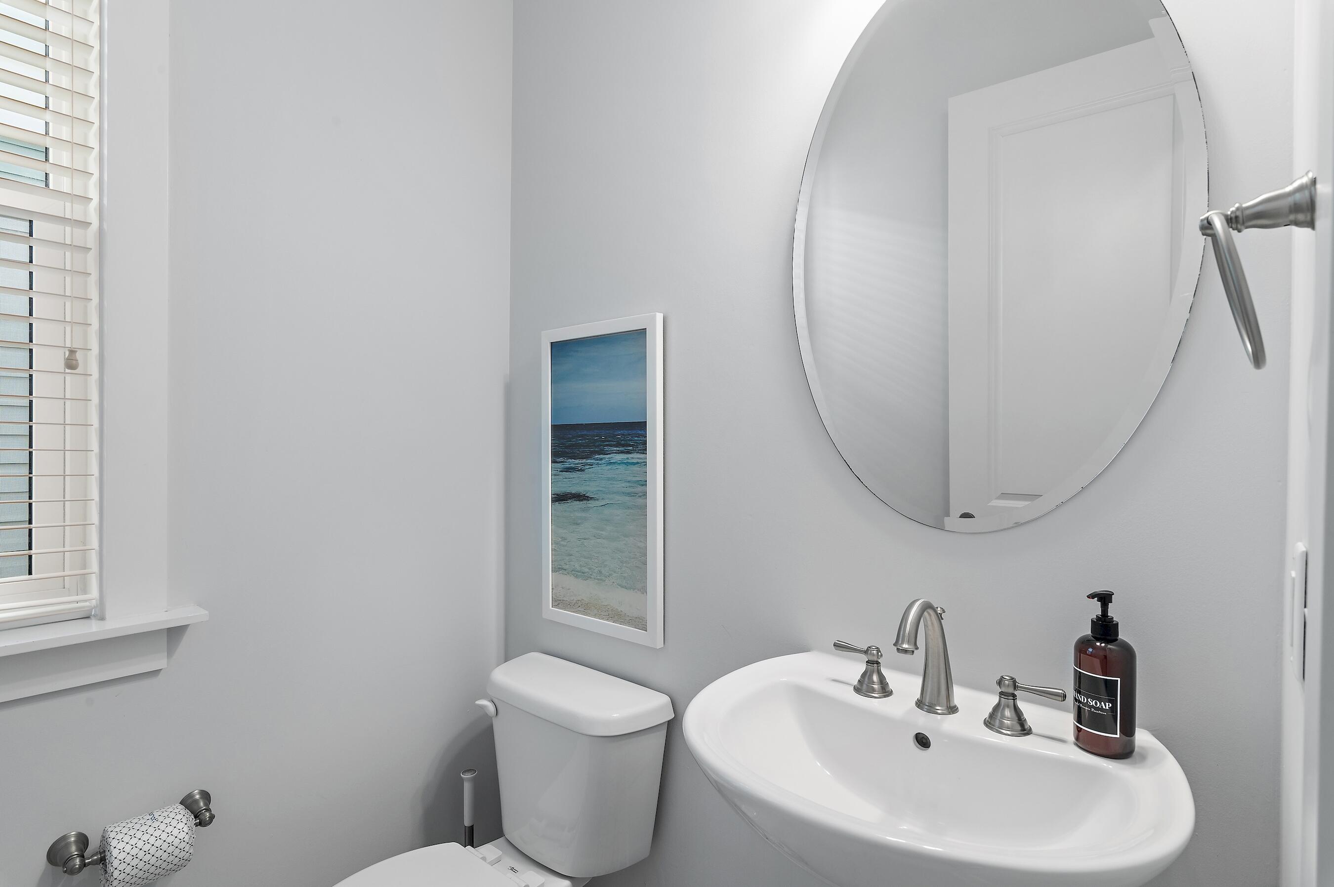 260 Flatwoods Forest Loop Santa Rosa Beach, FL 32459 - Photo 13 of 32 a bathroom with a sink and a mirror