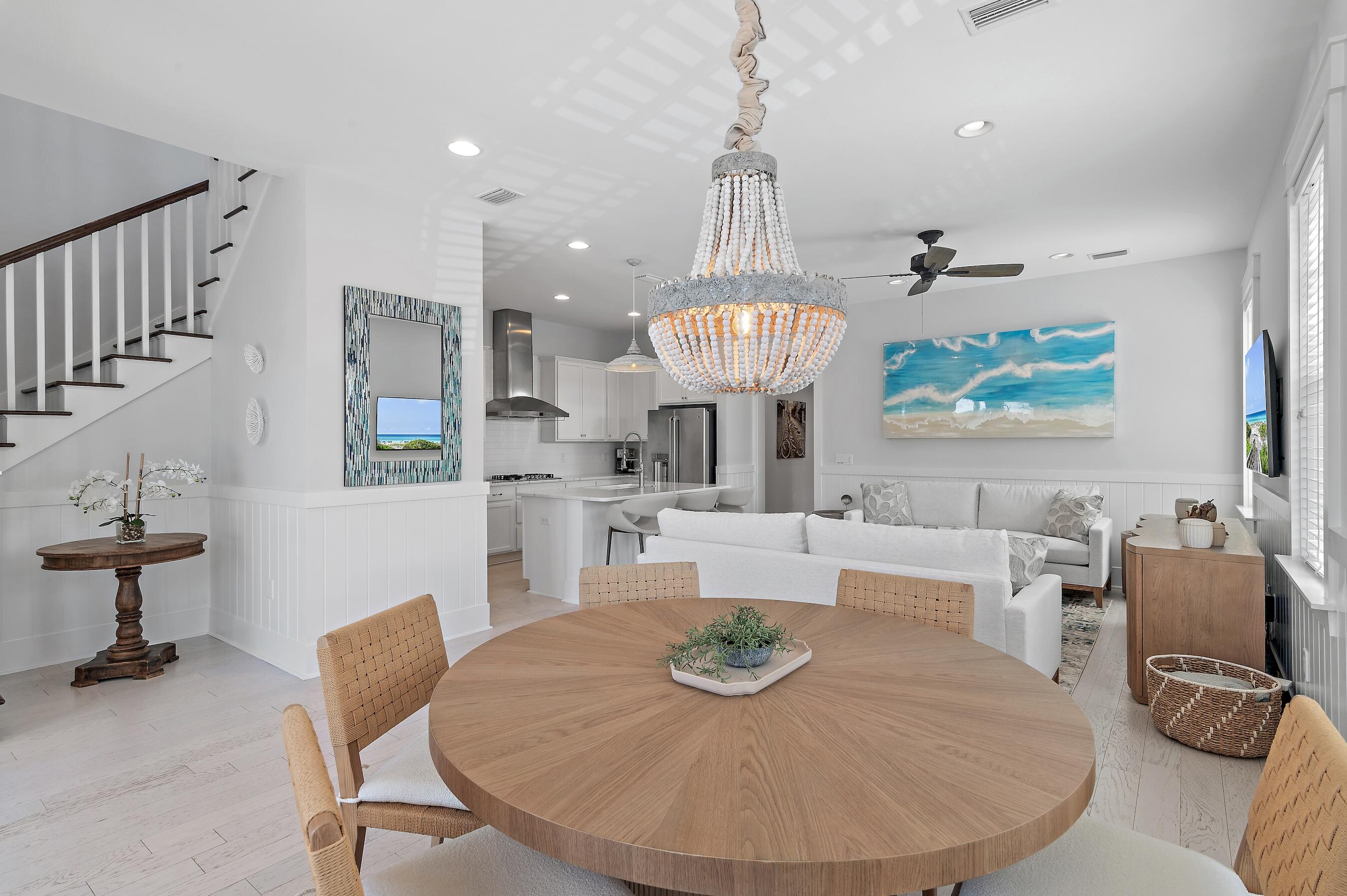 260 Flatwoods Forest Loop Santa Rosa Beach, FL 32459 - Photo 5 of 32 a living room with furniture a dining table and a chandelier