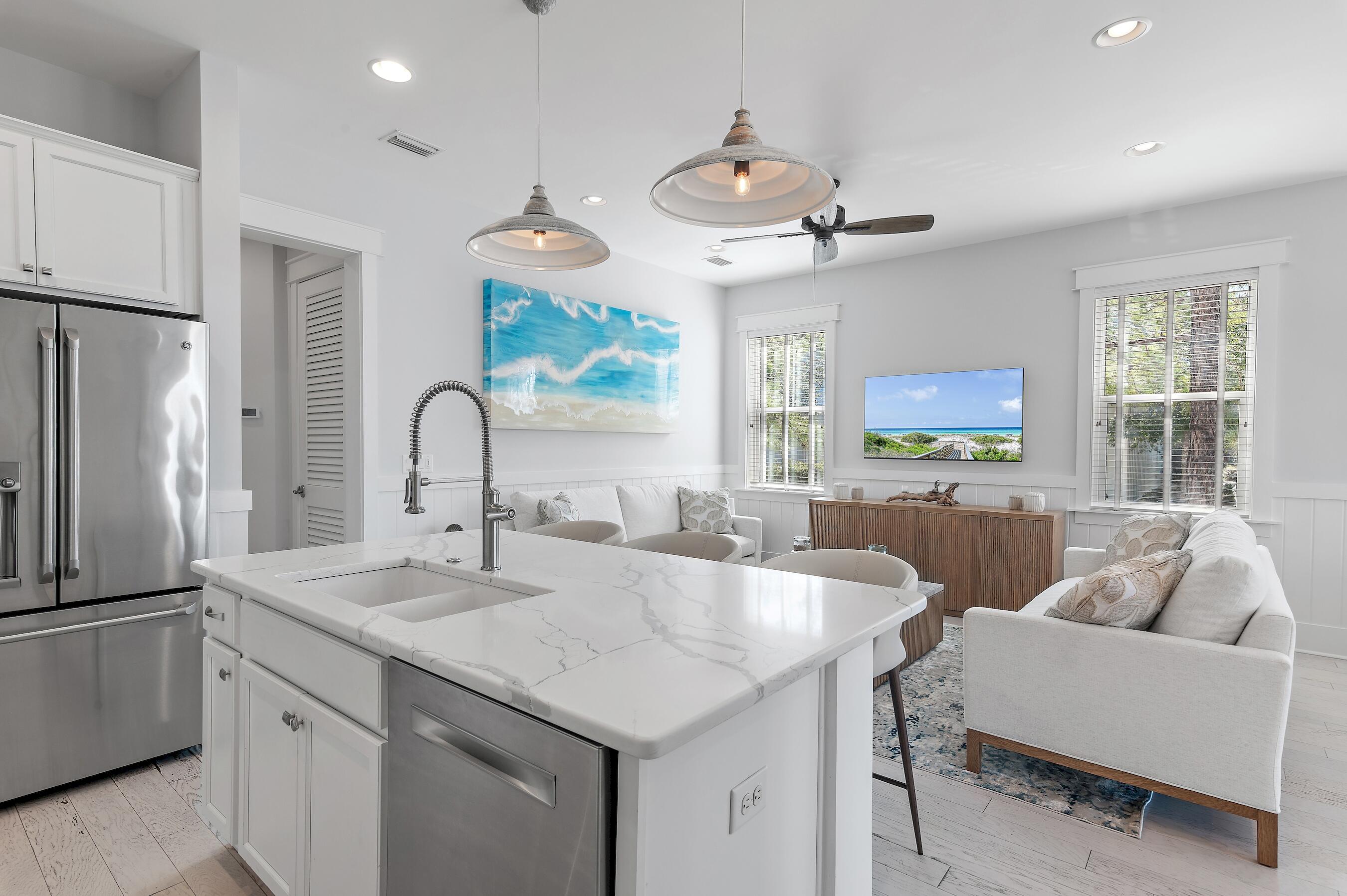 260 Flatwoods Forest Loop Santa Rosa Beach, FL 32459 - Photo 10 of 32 a kitchen with stainless steel appliances granite countertop a sink a stove and a refrigerator