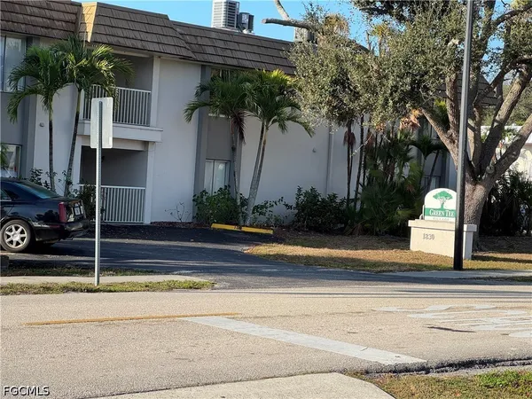 a view of a house with a patio and a yard