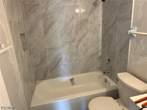 a bathroom with a toilet and a bathtub
