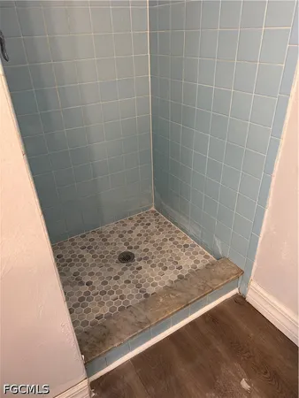 a bathroom with a granite countertop toilet and a sink
