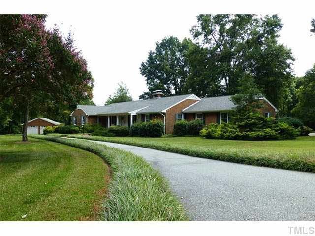 1555 Hanford Road Graham, NC 27253 - Photo 1 of 25 a aerial view of a house next to a big yard and large trees