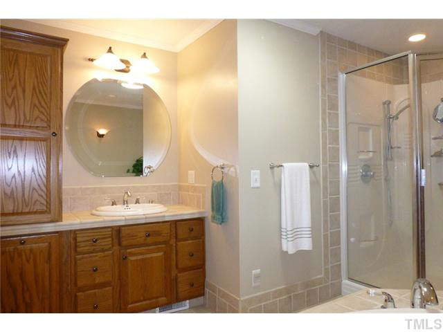1555 Hanford Road Graham, NC 27253 - Photo 15 of 25 a bathroom with a sink mirror and a shower