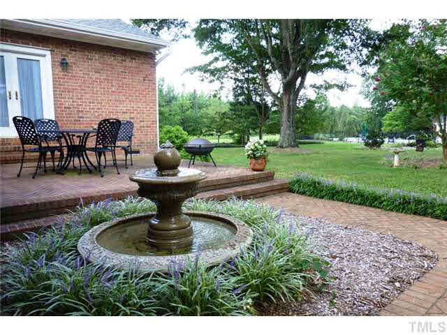 1555 Hanford Road Graham, NC 27253 - Photo 21 of 25 a view of a patio with table and chairs potted plants and a large tree