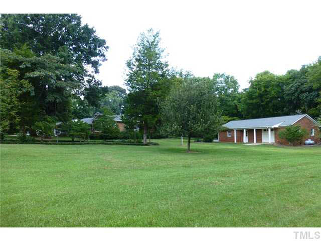 1555 Hanford Road Graham, NC 27253 - Photo 24 of 25 a backyard of a house with lots of green space