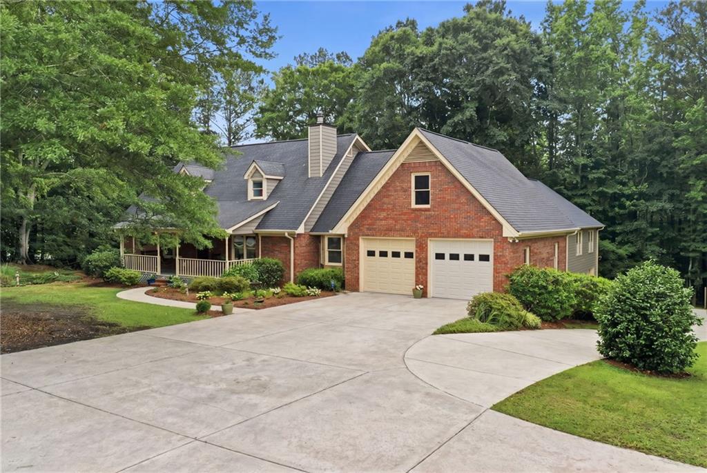 4891 Bill Cheek Road Auburn, GA 30011 - Photo 3 of 99 a front view of a house with a yard and garage