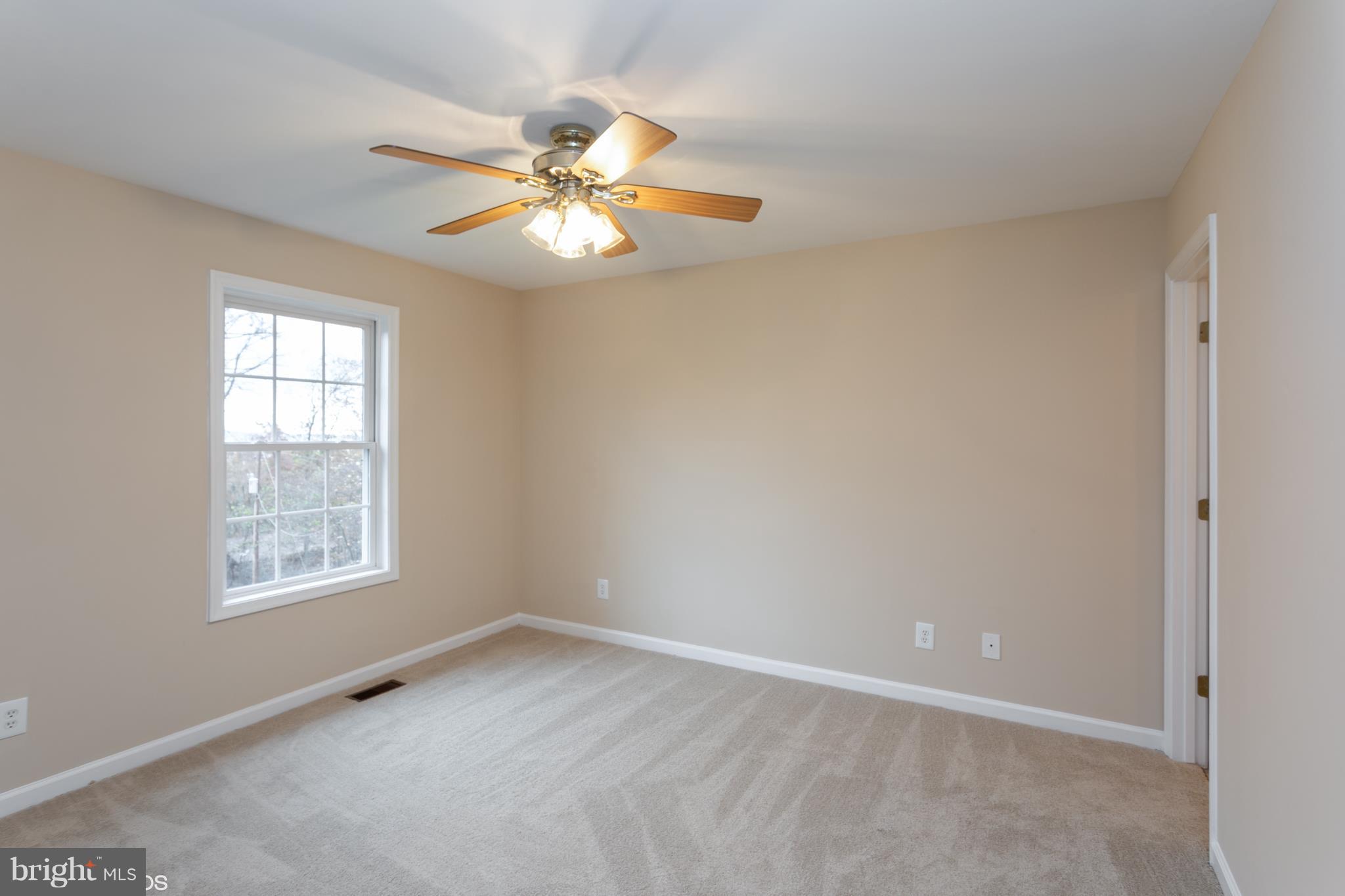 322 Freeze Road Linden, VA 22642 - Photo 14 of 26 an empty room with windows and fan