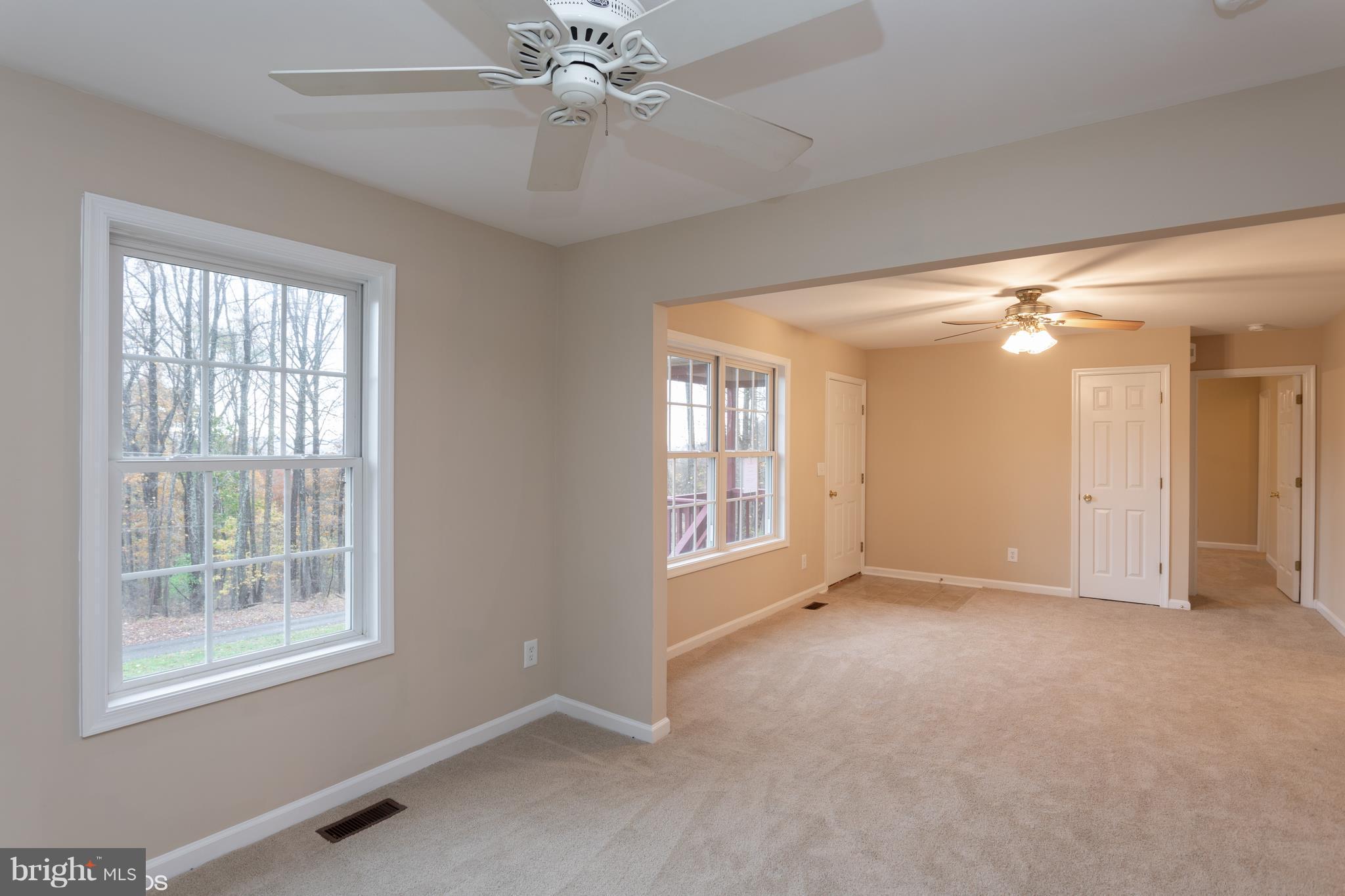322 Freeze Road Linden, VA 22642 - Photo 6 of 26 a view of an empty room with chandelier fan and fire place