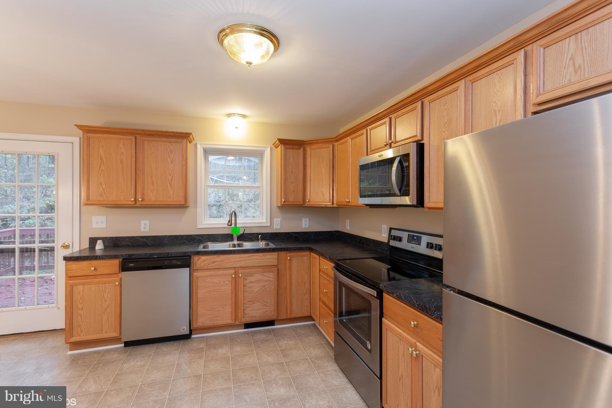 322 Freeze Road Linden, VA 22642 - Photo 7 of 26 a kitchen with granite countertop a refrigerator stove top oven and sink