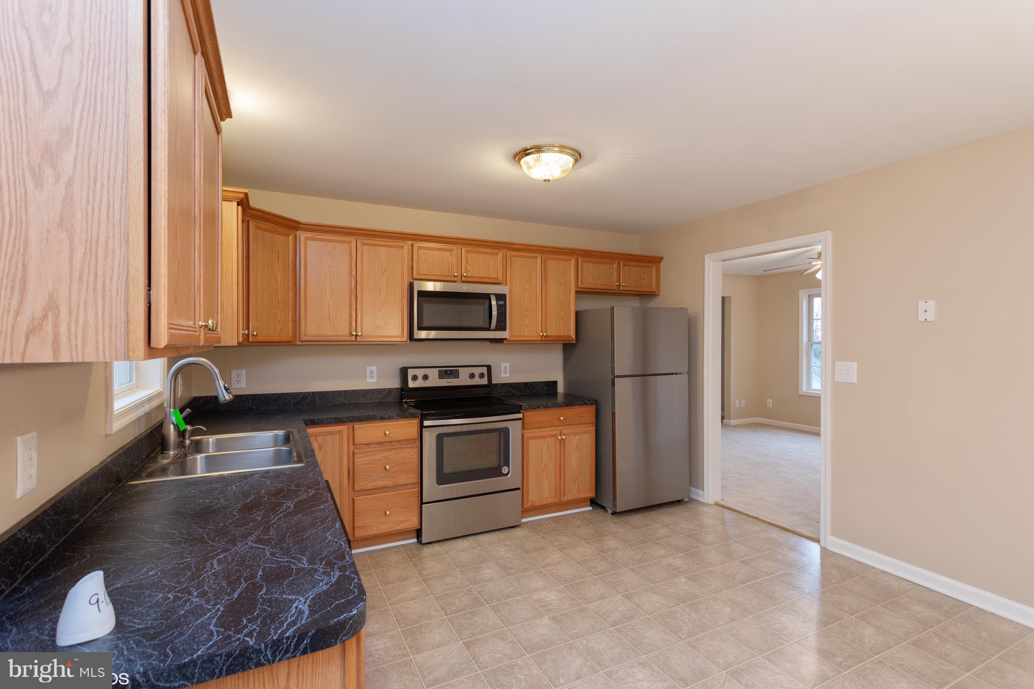 322 Freeze Road Linden, VA 22642 - Photo 8 of 26 a kitchen with stainless steel appliances granite countertop a stove a sink and a refrigerator