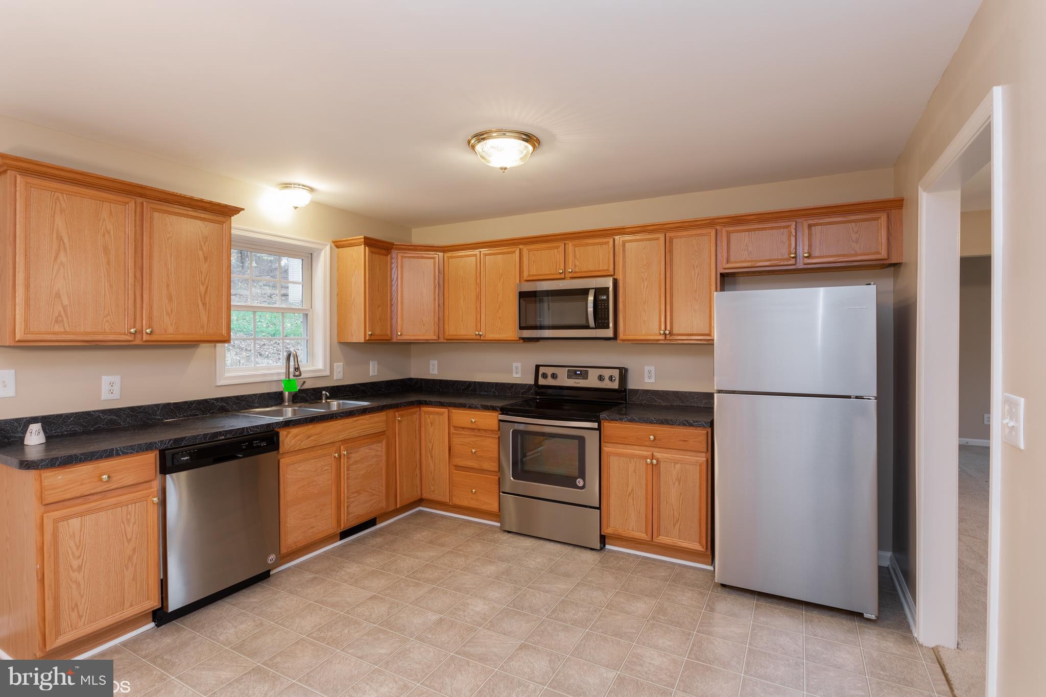 322 Freeze Road Linden, VA 22642 - Photo 9 of 26 a kitchen with stainless steel appliances granite countertop a refrigerator a stove a sink and a microwave