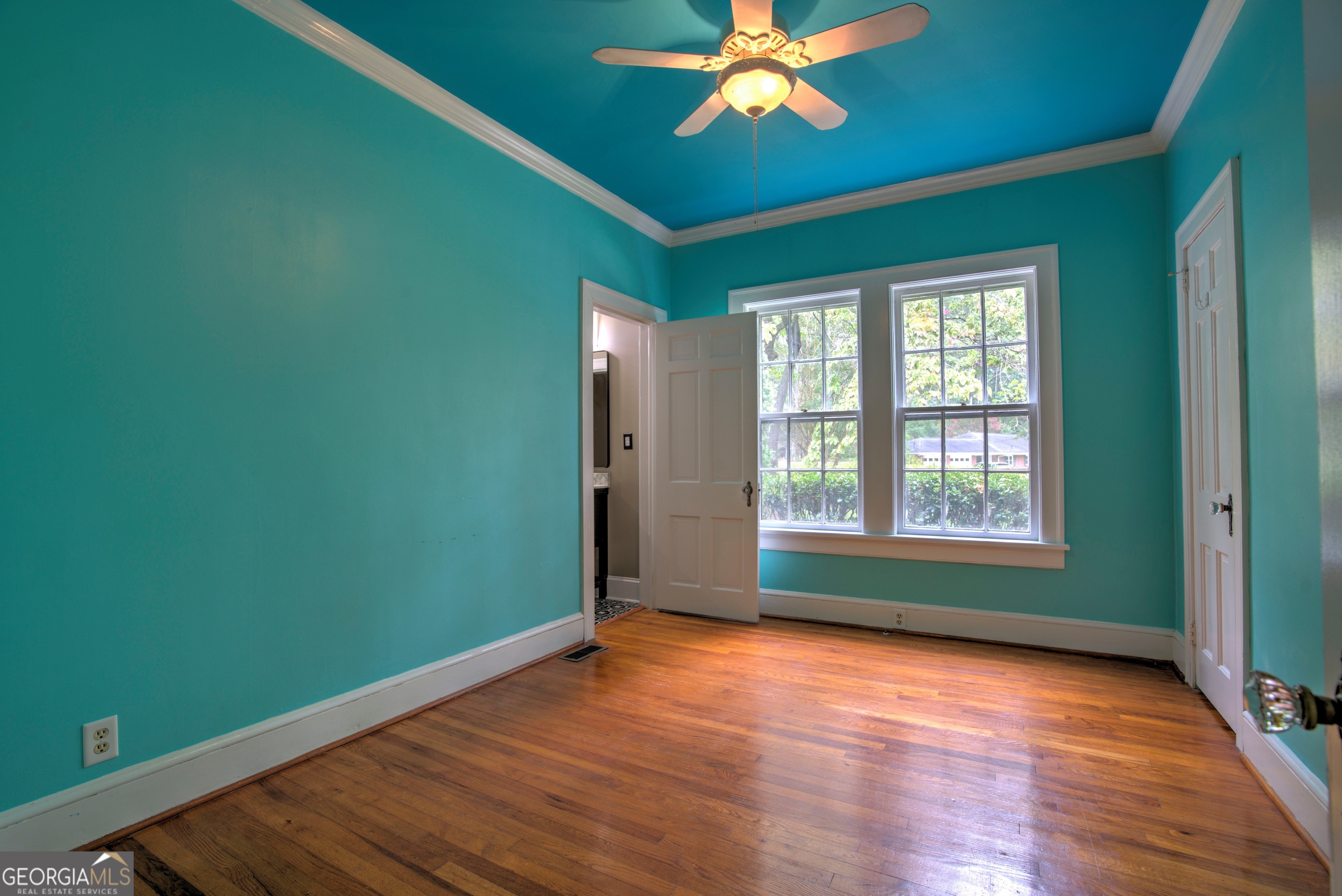 19 Berckmans Lane Southwest Rome, GA 30165 - Photo 12 of 26 an empty room with wooden floor fan and windows