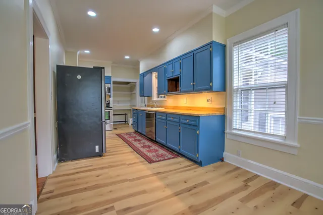 a view of kitchen with stainless steel appliances granite countertop a refrigerator and a sink