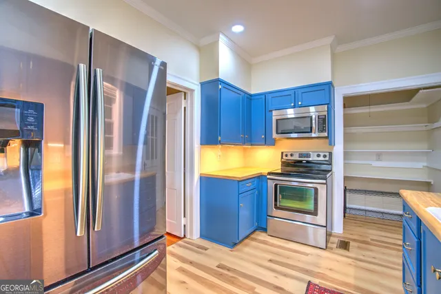 a kitchen with stainless steel appliances granite countertop a refrigerator and a sink