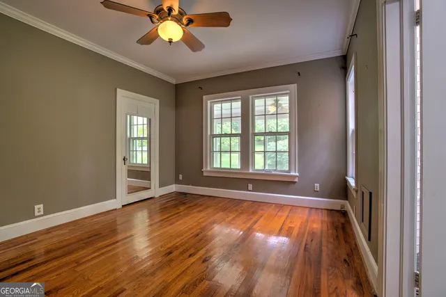 a view of room with window ceiling fan and hardwood floor
