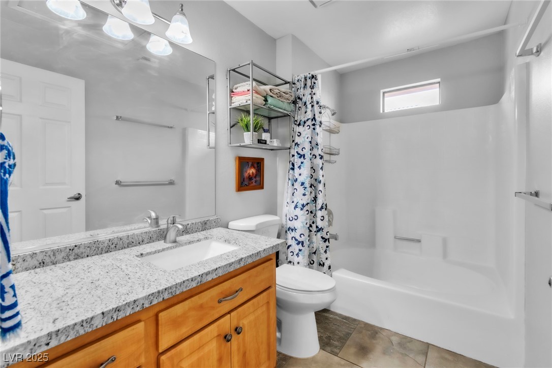 2995 East Sunset Road, Unit 235 Las Vegas, NV 89120 - Photo 16 of 24 Full bathroom featuring vanity and shower / bath combination with curtain