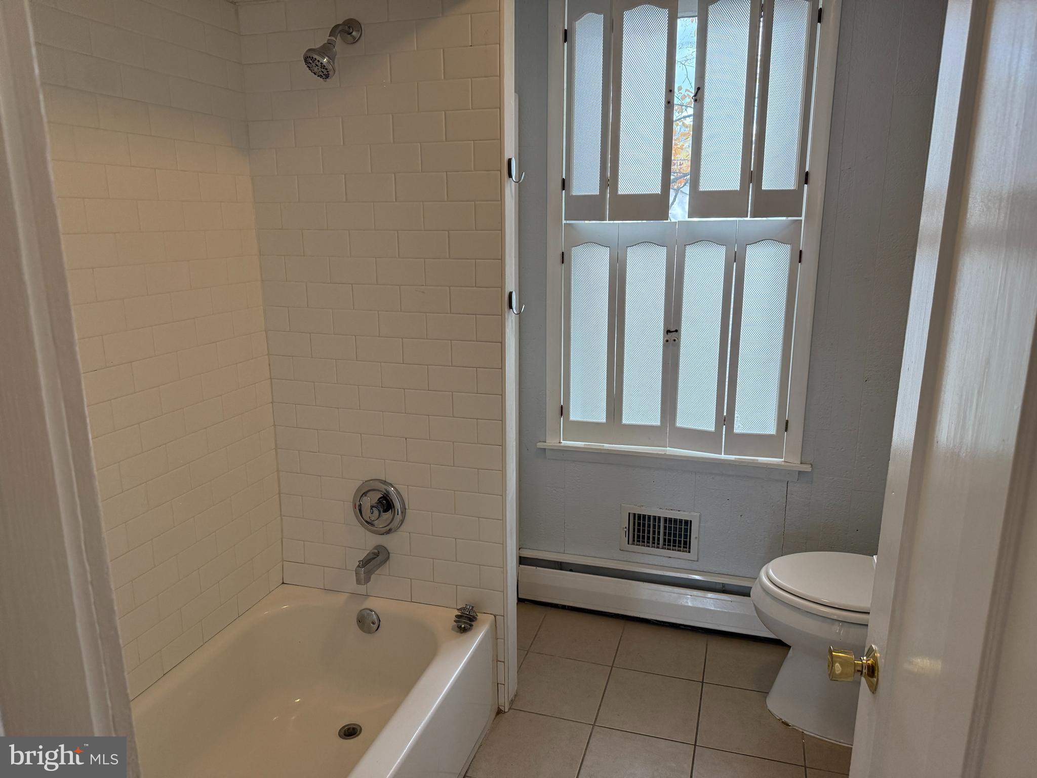 328 Hutchinson Terrace, Unit A Holmes, PA 19043 - Photo 16 of 27 a bathroom with a bathtub and toilet