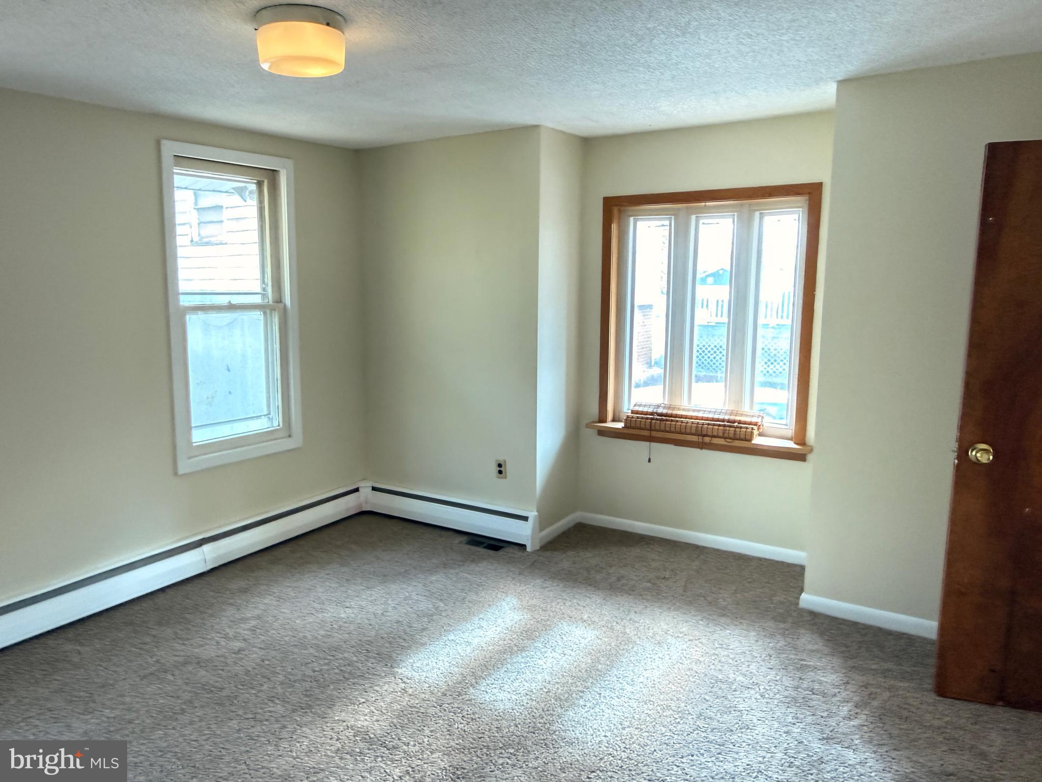 328 Hutchinson Terrace, Unit A Holmes, PA 19043 - Photo 18 of 27 an empty room with windows