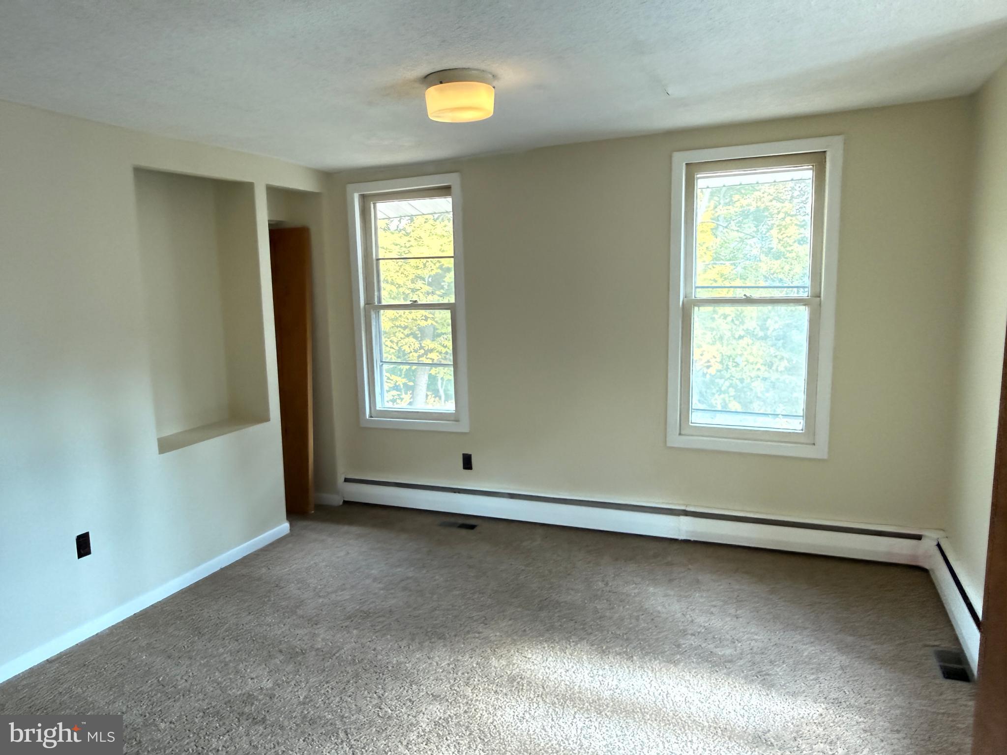 328 Hutchinson Terrace, Unit A Holmes, PA 19043 - Photo 19 of 27 a view of an empty room with a window