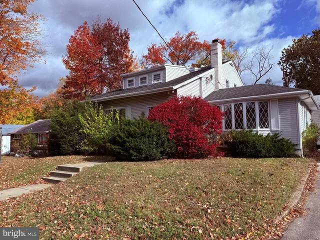 a view of a house with a yard and potted plants