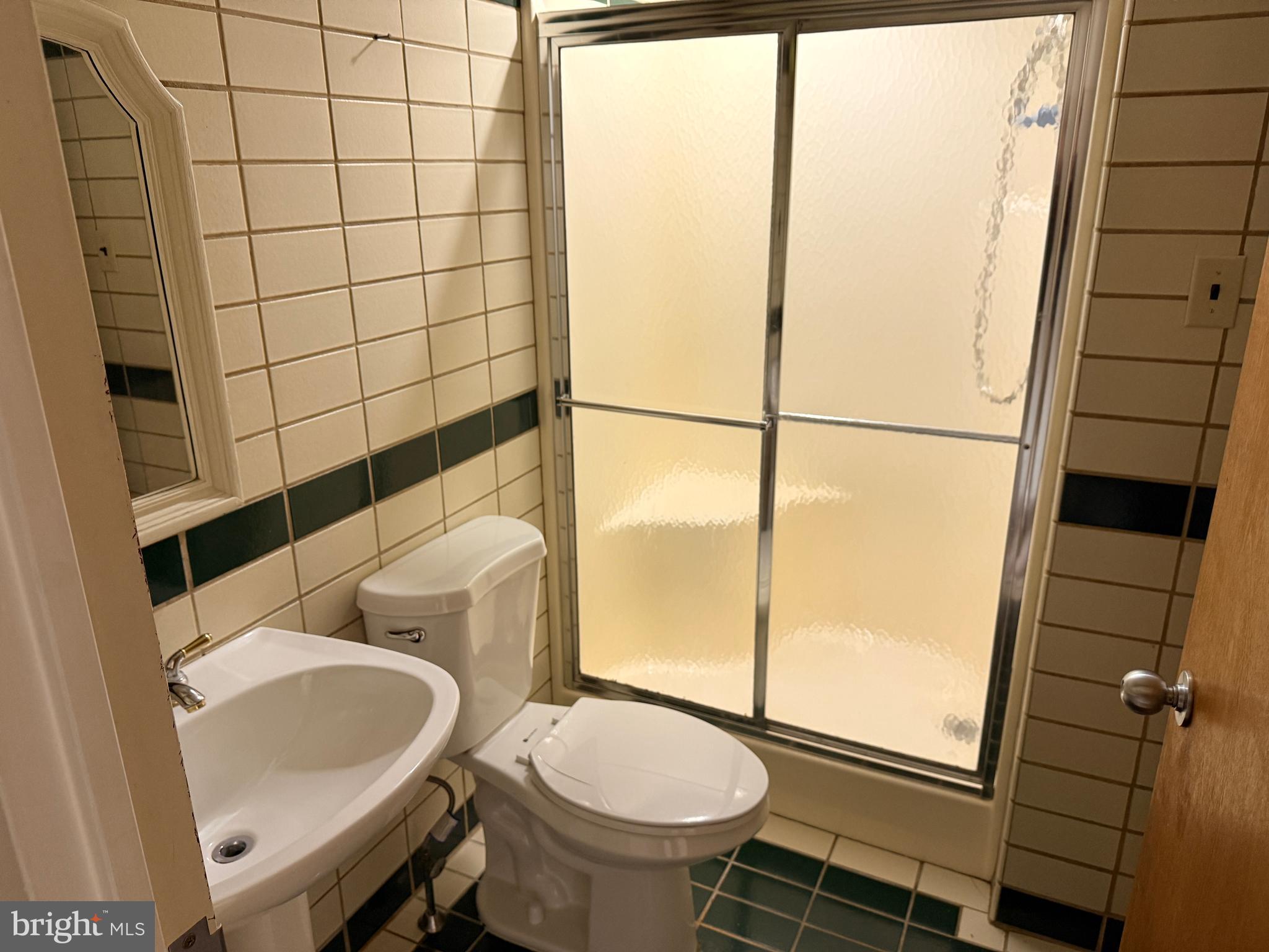 328 Hutchinson Terrace, Unit A Holmes, PA 19043 - Photo 26 of 27 a bathroom with a sink toilet and shower