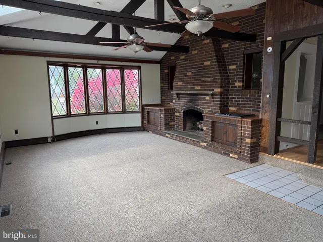 a view of an empty room with a fireplace