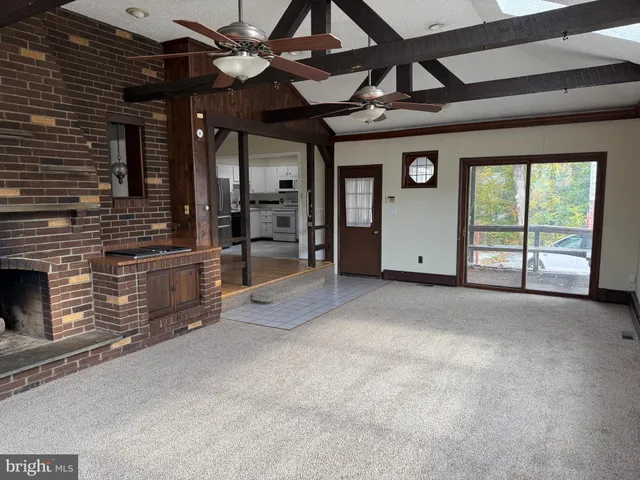 a view of an empty room with a fireplace