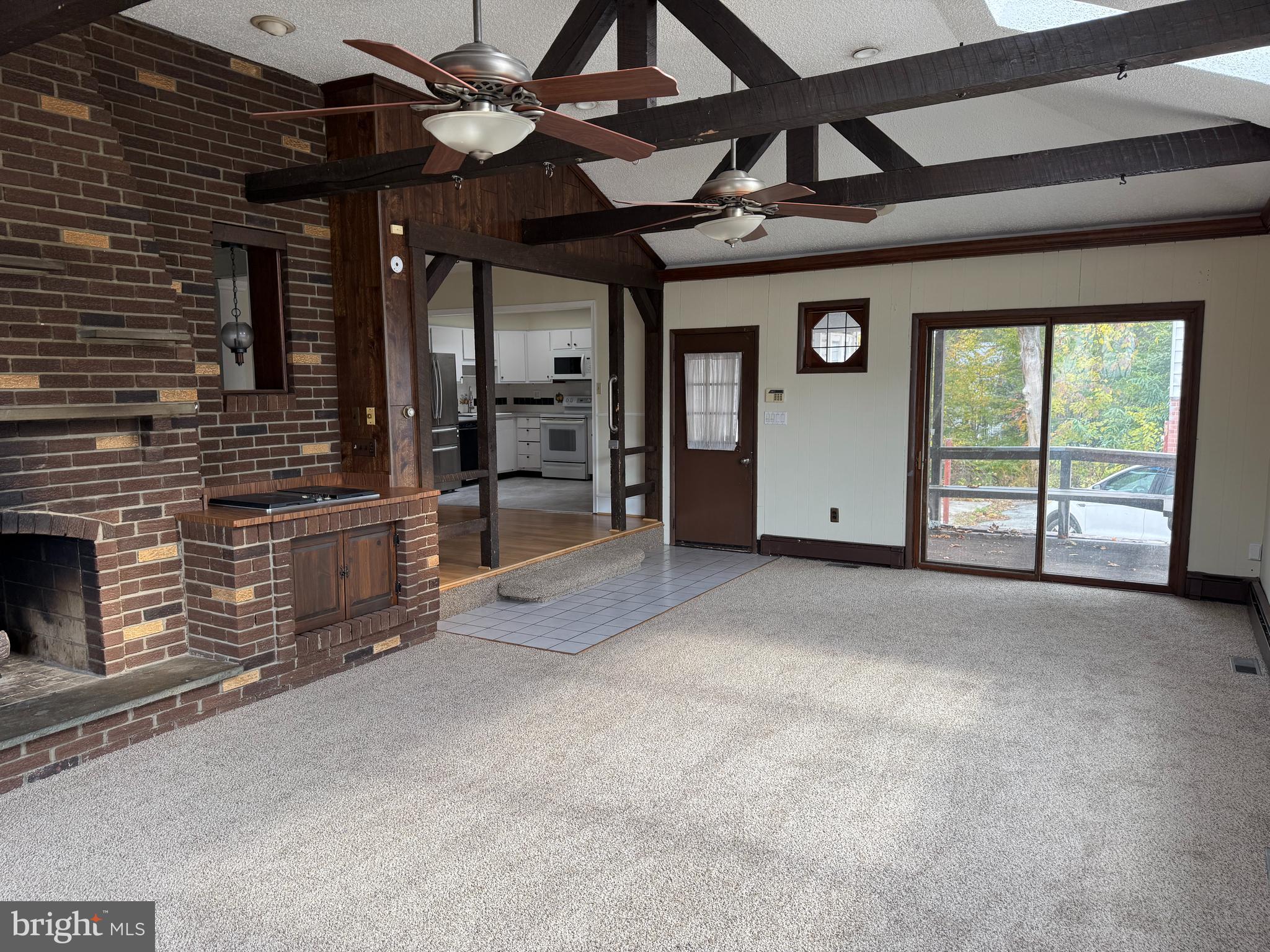328 Hutchinson Terrace, Unit A Holmes, PA 19043 - Photo 6 of 27 a view of an empty room with a fireplace