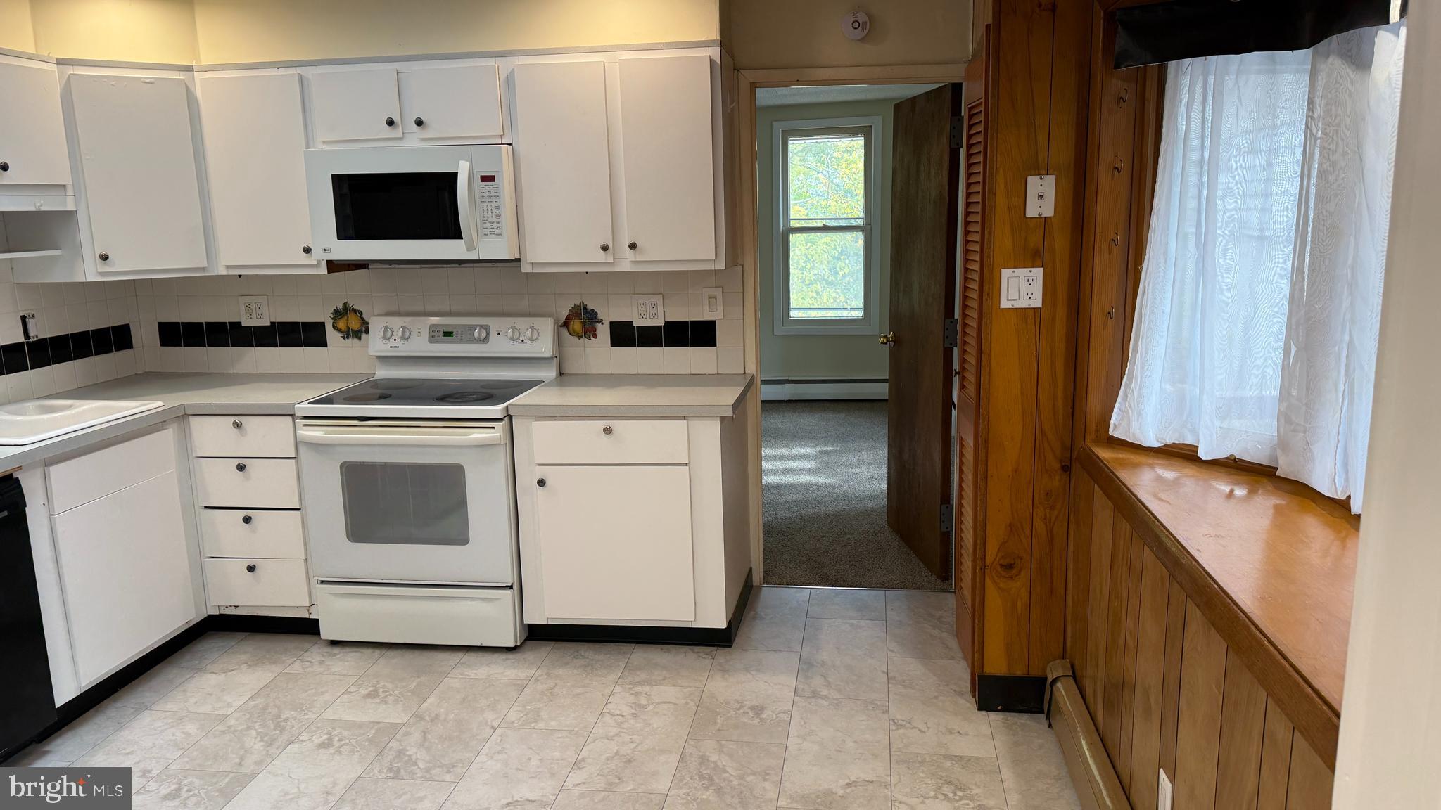328 Hutchinson Terrace, Unit A Holmes, PA 19043 - Photo 8 of 27 a view of a kitchen with stove and cabinets