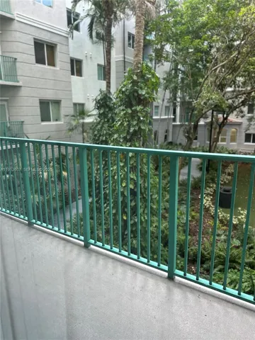 a view of a balcony with yard