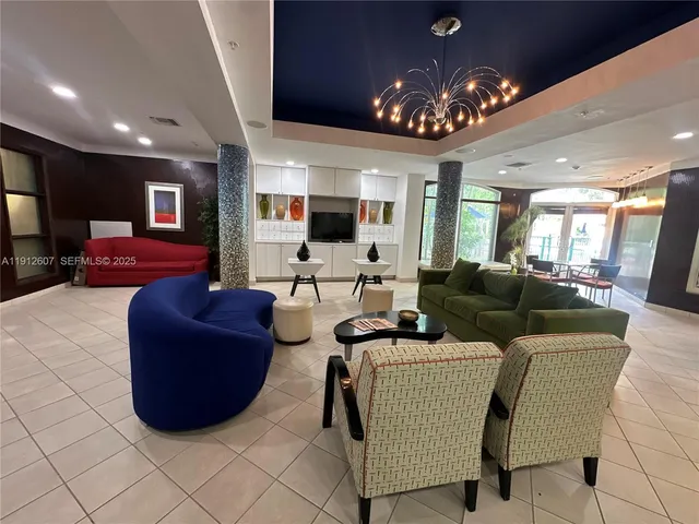 a living room with furniture a chandelier and a large window
