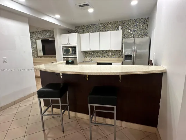 a kitchen with stainless steel appliances a sink and cabinets
