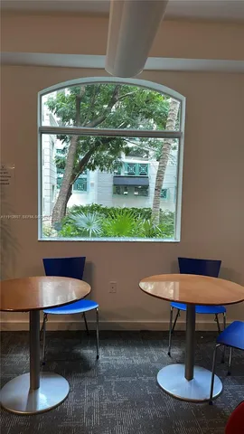 a living room with a table and a potted plant