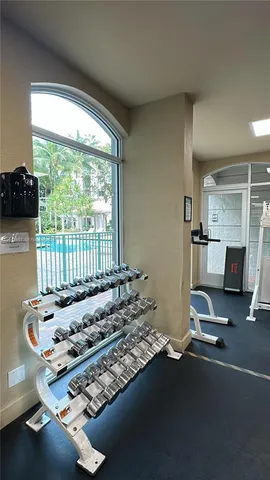 a room with gym equipment and a large window