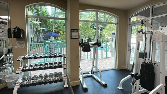 a bedroom with furniture and large windows