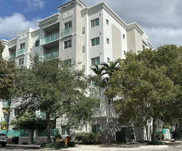 a front view of a building with trees